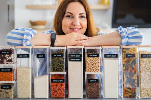 woman in her kitchen with dried pantry goods in sealed containers