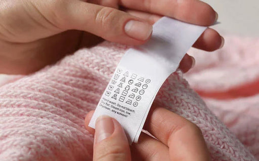 checking the hand wash care label on delicate fabric